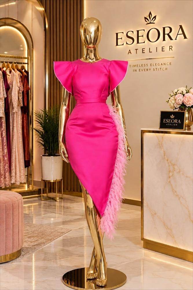 Pink satin dress with ruffle sleeves and feather trim by Eseora Atelier