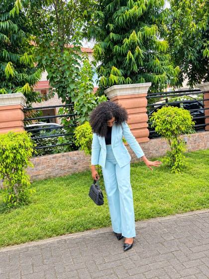 Powder blue blazer and wide-leg trousers worn outdoors